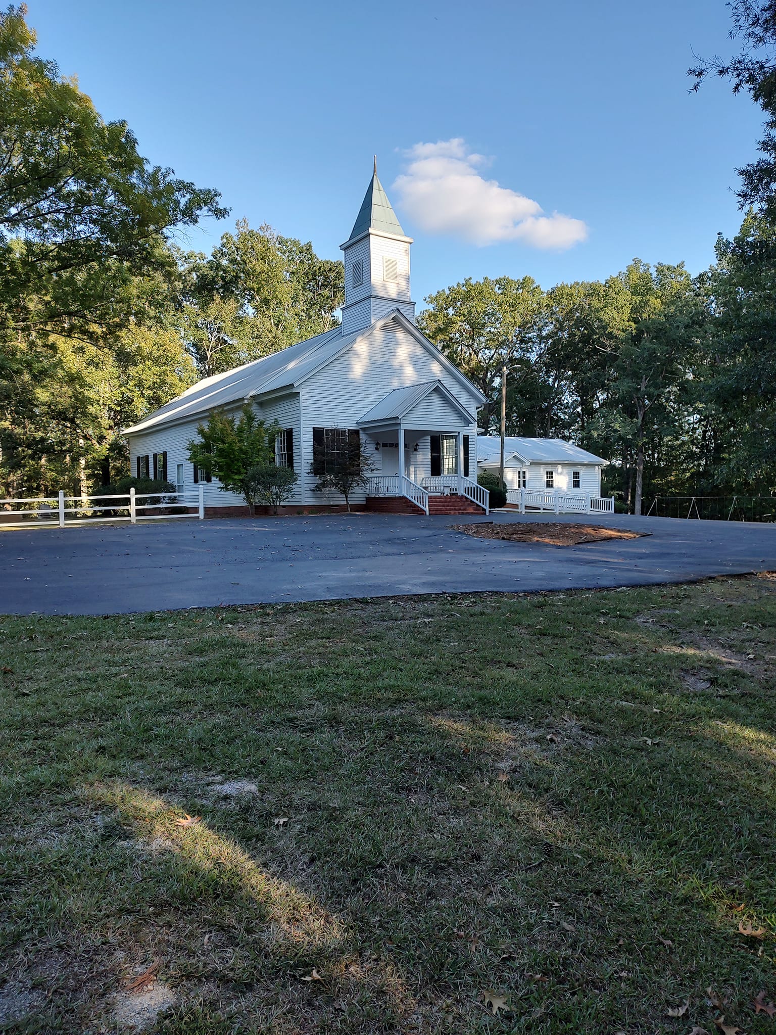 Greenwood Baptist Church sanctuary in Lincolnton, Georgia — a historic white wooden church surrounded by trees.